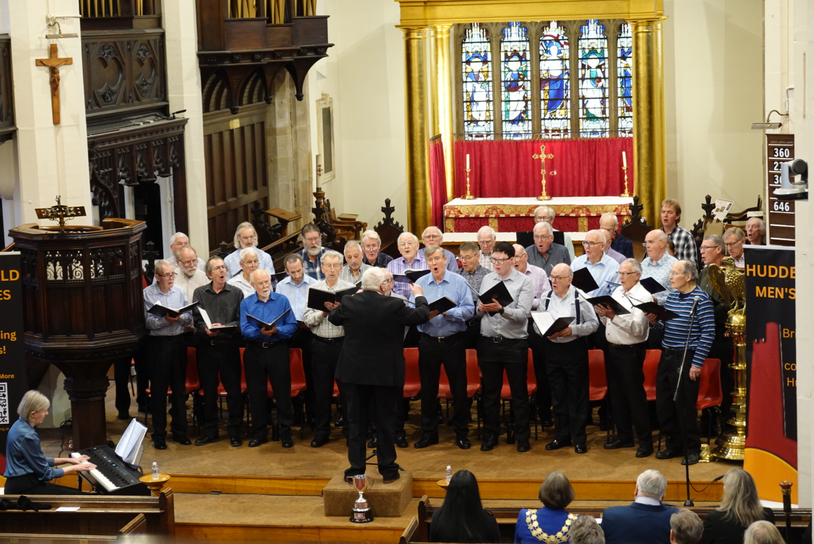 The Choir singing inside Huddersfield Parish Church, Jane is off stage to left on the panio.