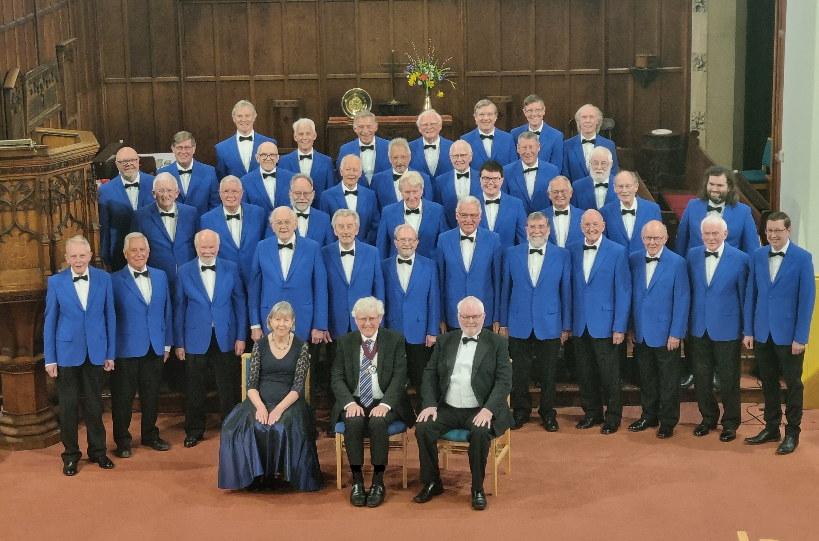 Gledholt Male Voice Choir inside a church wearing their blue blazers.